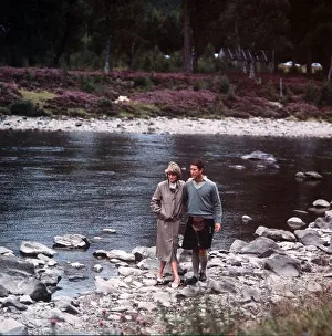 Prince Charles and Princess Diana walk along the River Dee at Balmoral