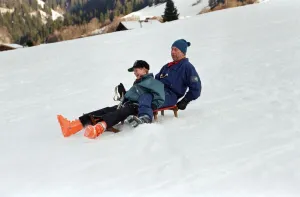 Sledging Prints: Prince Charles on a sledge with Prince Harry while on holiday in Klosters, Switzerland