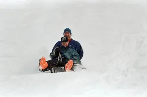 Prince Charles on a sledge with Prince Harry while on holiday in Klosters, Switzerland