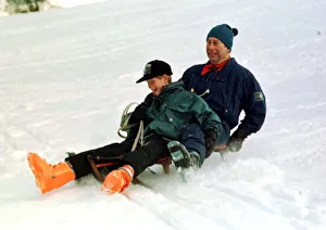 Prince Charles on a sledge with Prince Harry while on holiday in Klosters Switzerland