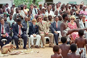 Prince Charles and his son Prince Harry watching dancers while on their visit to