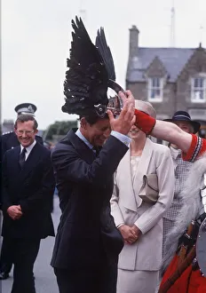 Prince Charles tries on a viking helmet watched by Princess Diana