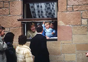 Prince Charles on a visit to Glasgow talking to family through window