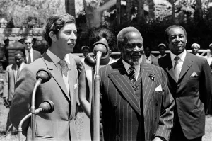 Prince Charles watches a traditional dance of welcome alongside the President of Kenya