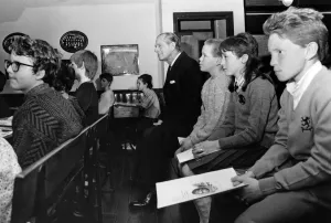 01323 Prints: Prince Philip, Duke of Edinburgh takes a seat in the Heritage Centre classroom at Wigan