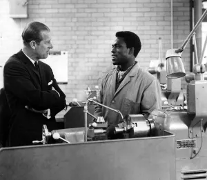 01329 Prints: Prince Philip, Duke of Edinburgh takes an interest in the work of Adeddyin Otenaike of