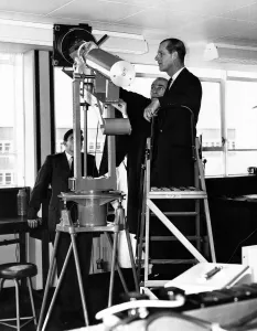 Prince Philip visiting Wales. Mr D A Richards explains the camera for the optical