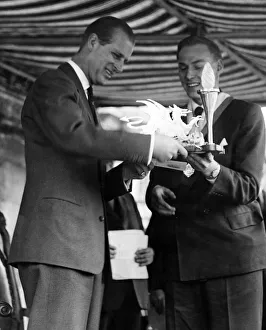 01037 Prints: Prince Philip visiting Wales. A scroll and electric lamp stand is presented to the Duke