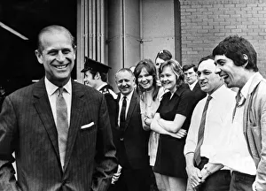 Meeting Prints: Prince Philip visiting Wales. A smiling Duke of Edinburgh turns after talking to workers
