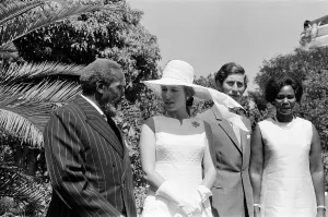 Princess Anne and Prince Charles watch a traditional dance of welcome alongside
