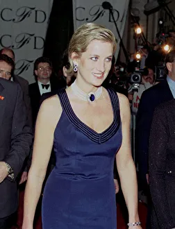 Princess Diana gels her hair and a blue evening dress with pearl necklace at the Council