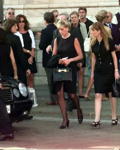 Princess Diana leaves a memorial service for slain Italian fashion designer Gianni
