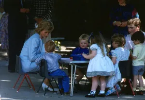 Princess Diana pictured with nursery school children during a visit to the Barnardo