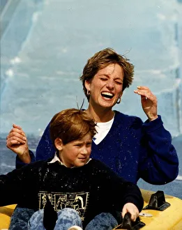 Princess Diana and Prince Harry laughing and getting soaked on water slide ride in Thorpe