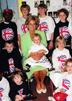 Princess Diana Princess of Wales with James Perry sitting on her knee during a visit to a