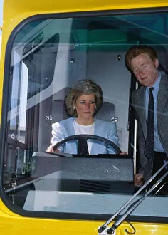 00065 Prints: Princess Diana, Princess of Wales at the wheel of a bus watched by John Fowler during a