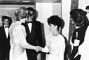 Princess Diana shakes hands with actress Joan Collins at a Bruce Oldfield London fashion