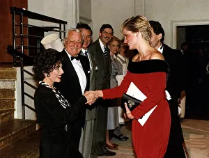 Princess Diana shakes hands with actress Joan Collins after a charity performance of