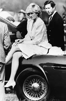 Princess Diana sitting on the bonnet of Prince Charles cherished J reg Aston Martin car