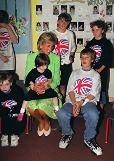 Princess Diana sitting with Caitlin Hines on her lap during a visit to a children