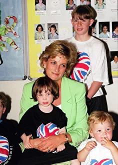 Princess Diana sitting with Caitlin Hines on her lap during a visit to a children