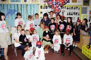 Princess Diana with six year old Jamie Poore sitting on her knee during a visit to a