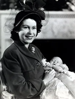 Princes Prints: Princess Elizabeth holds her baby son Prince Charles in the drawing room at Buckingham