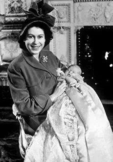 00476 Prints: Princess Elizabeth holds her baby son Prince Charles in the drawing room at Buckingham