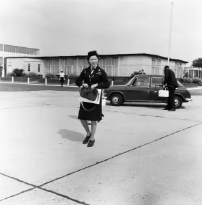 Princess Margaret in Girl Guide uniform leaving Heathrow Airport to fly to Shawbury