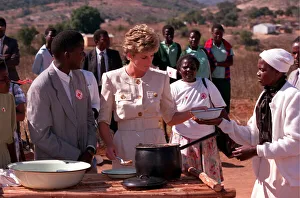 01416 Prints: PRINCESS OF WALES DISHING OUT FOOD DURING A VISIT TO RED CROSS CHARITY PROJECT IN