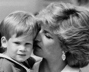 Spain Prints: Princess of Wales holds her young son Prince Harry on holiday in Majorca, Spain