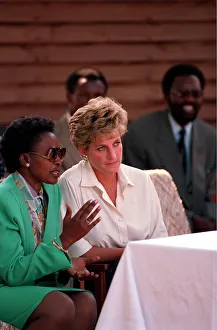 PRINCESS OF WALES WEARING SUNGLASSES AND SMILING DURING A VISIT TO RED CROSS CHARITY