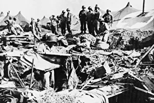 Tents Prints: Private Robert Phillips retrieves a cot from a bomb crater after an American hospital