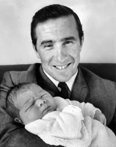 Proud Prints: Proud father racing driver Jackie Stewart seen here holding his son Paul Evan