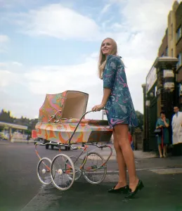 Psychedelic paisley pram with blonde woman wearing psychadelic mini dress Produced