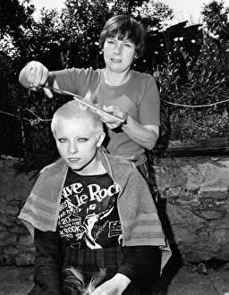 Punk girl Julie Brandon having her hair cut by her mother at their home in Thame