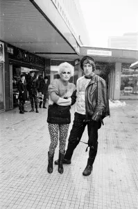 Winter Prints: Punk Rock fashions in Birmingham. A young woman and man standing outside in a shopping