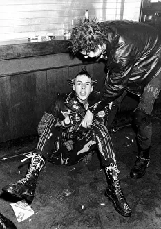 Punks at the 100 Club. Drunken Punk sitting amongst broken plastic beer glasses