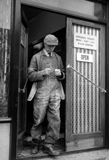 00170 Prints: A punter leaves a betting shop in London after placing his bet May 1961