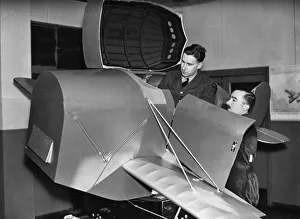 01029 Prints: A pupil emerging from the Link trainer used for initial instruction at an RAF training
