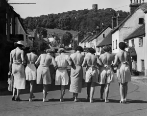 Putting their backs into their holiday. A group pf women walking down the street wearing