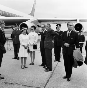 The Queen, The Duke of Edinburgh and Princess Anne waiting to board the plane for a 10