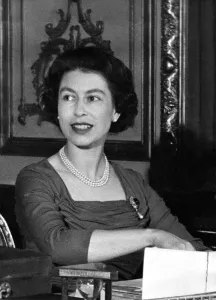 00086 Prints: Queen Elizabeth II at her desk in Buckingham Palace looking through her correspondence
