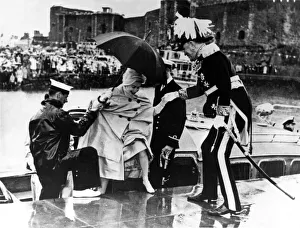 Queen Elizabeth II gets a helping hand from Governor Lord Wakehurst