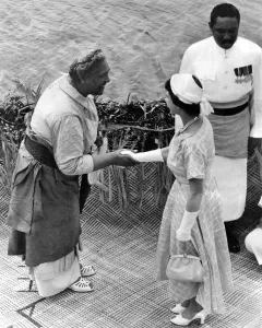 Queen Elizabeth II is greeted by Queen Salote of Tonga on arrival at Nuku Alofa during
