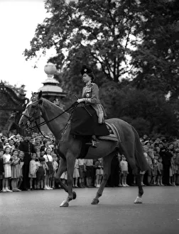 Queen Elizabeth II rides her horse sidesaddle June 1953 towards horseguards parade