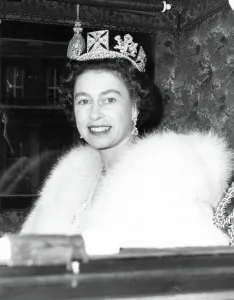 Queen Elizabeth II smiles at cameraman as she left the quadrangle of Buckingham Palce in