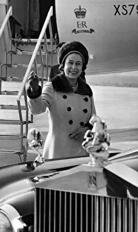 Images Dated 9th March 1973: Queen Elizabeth II waves to onlookers, as she walks to her car from the aircraft