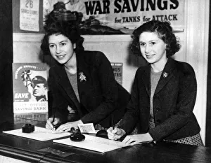 Queen Elizabeth and her sister Princess Margaret buying war savings certificates at a