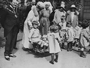 Queen Mary visits Orphanage. Queen Mary and local mayor visit orphans at playtime